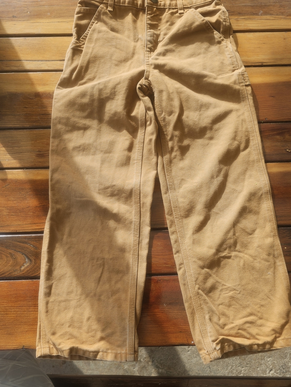 a pair of size 10 Carhartt youth bib overalls made of 100% cotton canvas. 